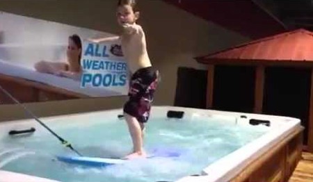 Boy learning to surf in a All Weather Pool